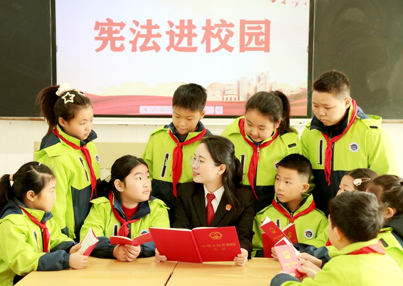 041764814253543751.jpg 法官帶領(lǐng)孩子們一起讀憲法、學(xué)憲法.jpg